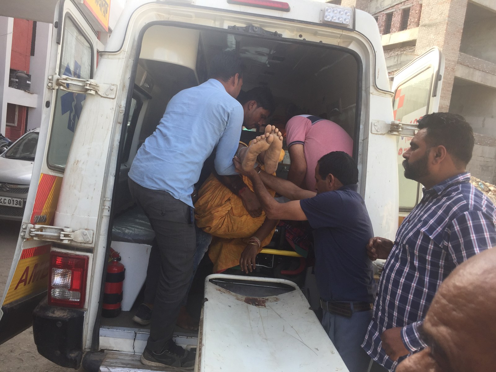 Volunteers Safely Securing and Loading Injured Patient into Emergency Ambulance