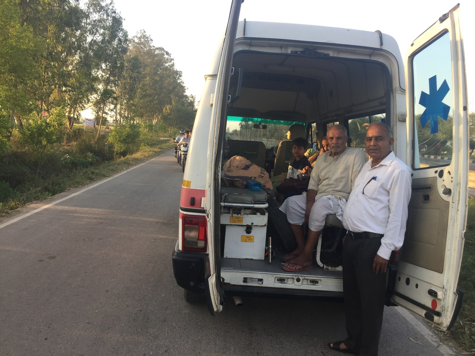 Compassionate Volunteer Accompanying Seated Patient to Healthcare Facility